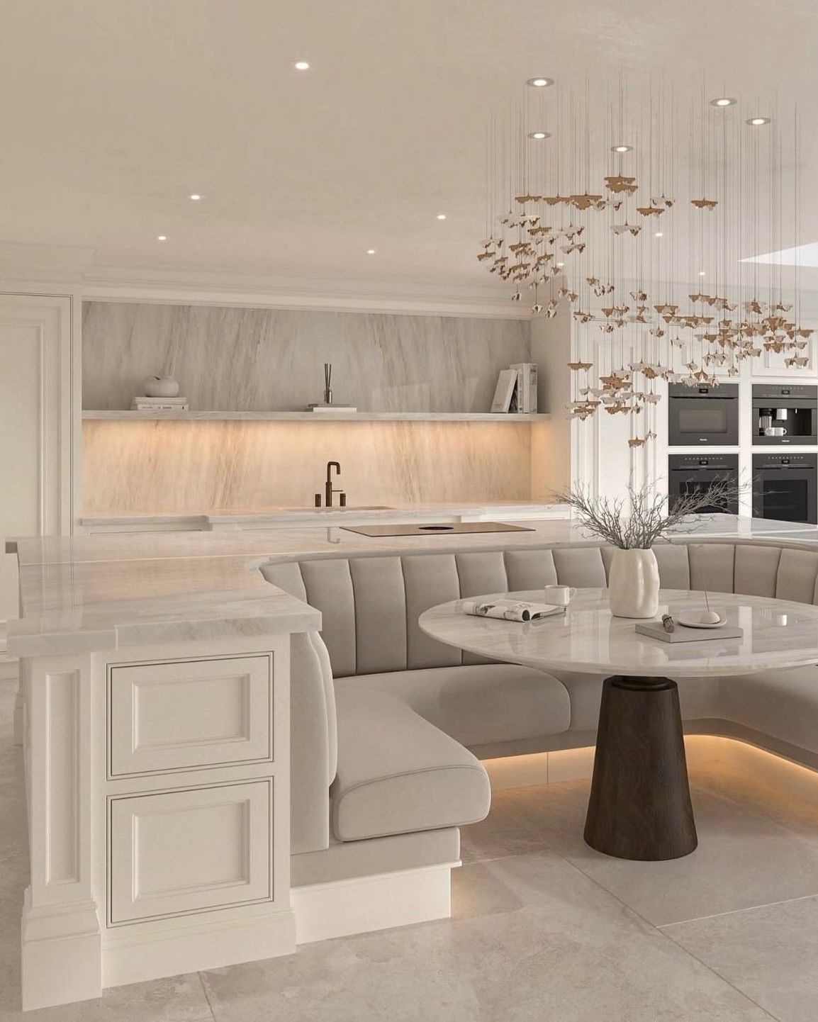 Luxury kitchen with butterfly chandelier and banquette by Lance Interiors